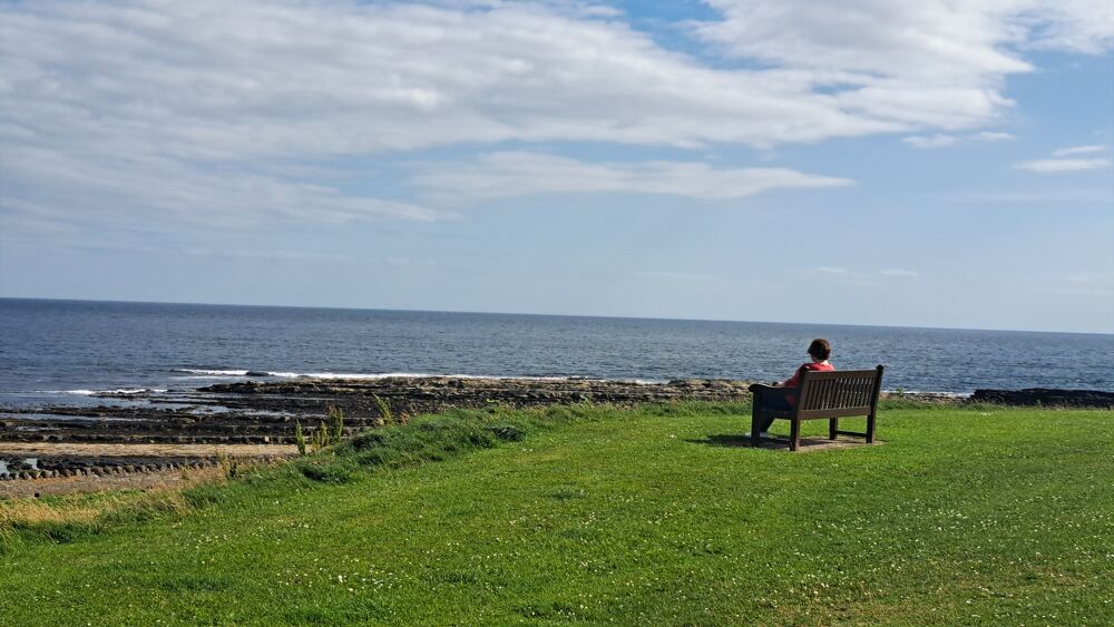 Lady siting on a bench looking out on Raad ny Foillan Lady siting on a bench looking out on Raad ny Foillan